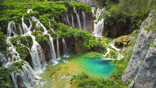 Summer forest and mountain landscape with streams of water and waterfalls. Cascades flow among lush