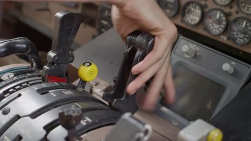 Airplane pilot in the cockpit, taking off, suing the throttle.