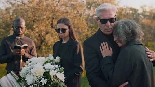 Mourners Gather at Funeral Ceremony Outdoors