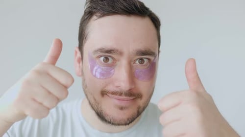 Man Wearing Eye Patches Gives Thumbs Up