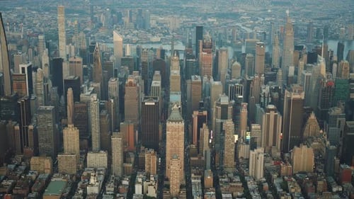 Aerial shot of New York City skyline while the sun is setting.