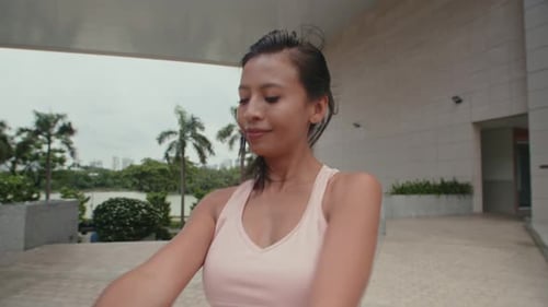 Woman Stretching Arms for Exercise in Urban Setting