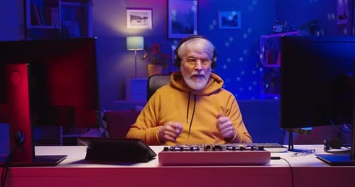 Gray Haired Man with Beard Talking on Computer