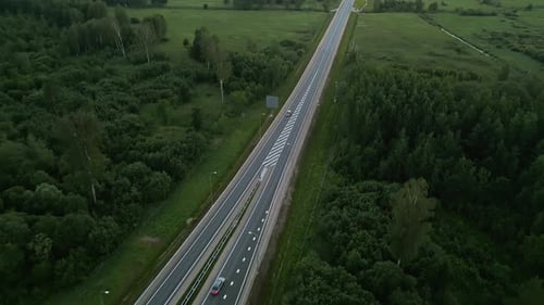 An Aerial View of a Serene Highway with Lush Green Landscapes Provides a Peaceful and Scenic Outlook