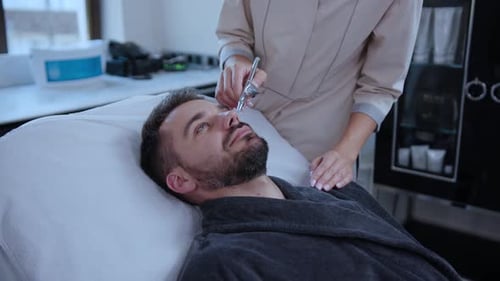A Man Enjoys a Rejuvenating Facial at a Tranquil Spa Designed for Relaxation and Wellness