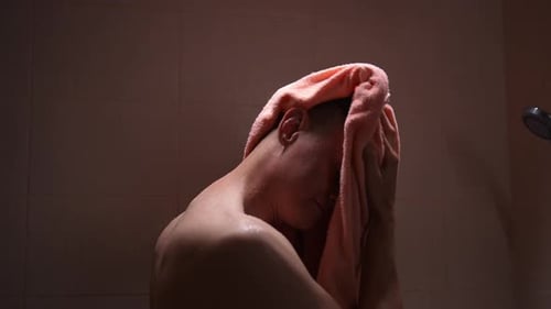 Man Drying Off After Shower With Pink Towel