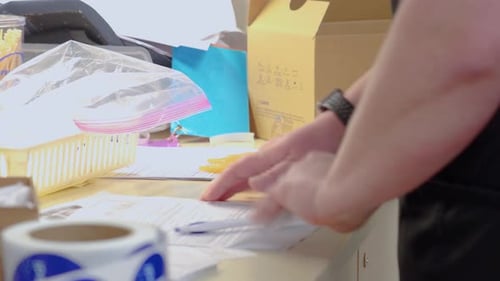 Medical Worker Organizes Syringes on Desk