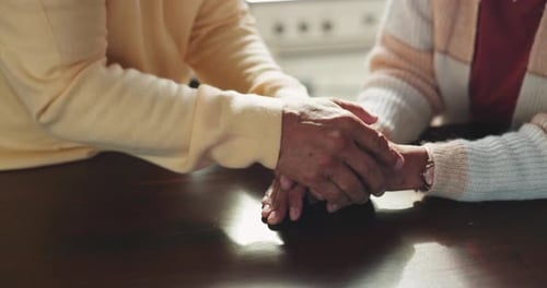 Love, empathy and senior couple holding hands for support, unity and care while in conversation