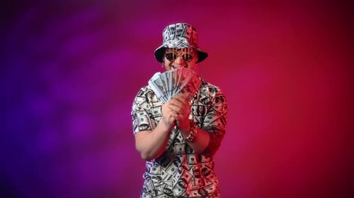 Portrait of Happy Rich Man in Studio Crazy Millionaire Swaying By Dollars Holding Cash in Hands