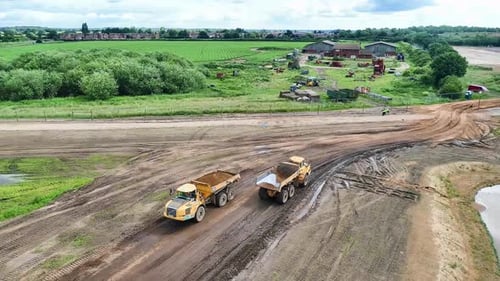 Dump Trucks Move on Construction Site, Aerial View