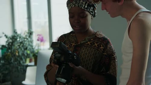 Female Photographer and Model Discussing Photos in Studio