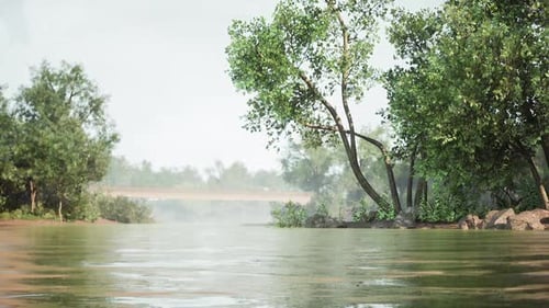 Calm River Landscape with Lush Greenery and a Distant Bridge in the Morning