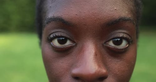 Close up of young bald african girl looking at camera