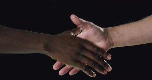 Diverse Hands Shaking Against Black Background