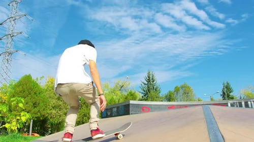 Man Doing Skateboard Trick on Sunny Day