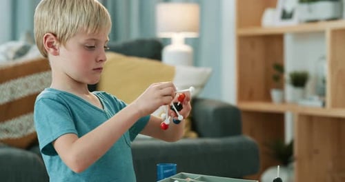 Young Blond Boy Builds Molecule Model at Home