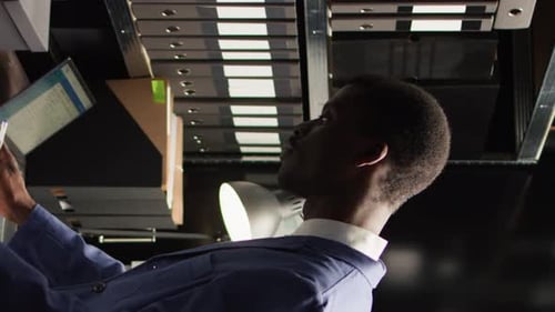 Man Reviews Documents in a Business Office