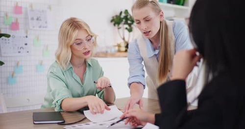 Women Collaborating on Project in Office Workspace