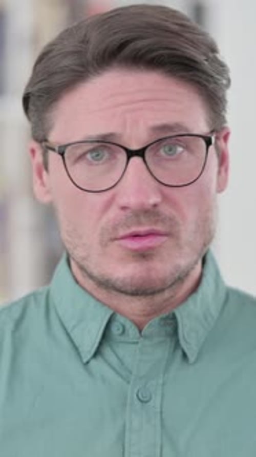Adult Man with Glasses Looking Directly at Camera