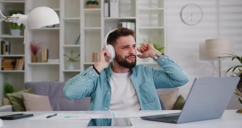 Man With Headphones Dancing at Desk