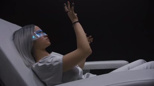 Metaverse blonde girl plays augmented reality touching invisible object in empty room