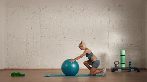 Woman Performing Back Stretch with Exercise Ball