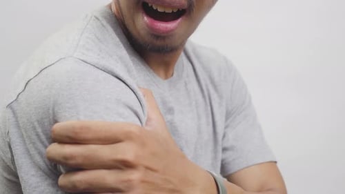 Adult Man Rubbing his Sore Shoulder