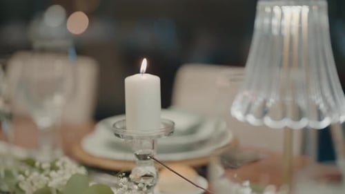 Lit Candle in Glass Holder on Elegant Dinner Table Setting