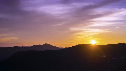 Sunrise landscape on the top of the mountain, with colorful clouds in the sky.