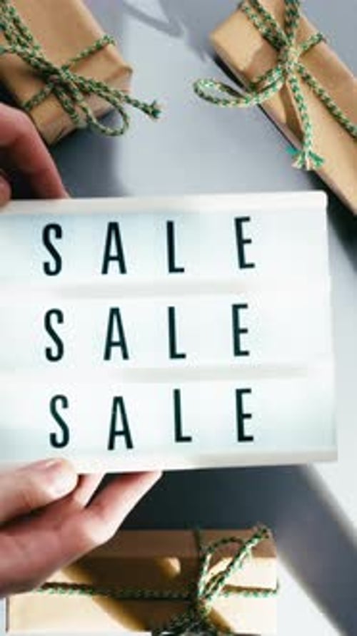 Sale Display with Wrapped Gifts and Hand