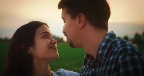 Young Couple Hugging and Kissing Outdoors on a Countryside Road with