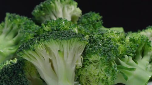 Broccoli pieces rotating on black background, Close Up Detail Shot