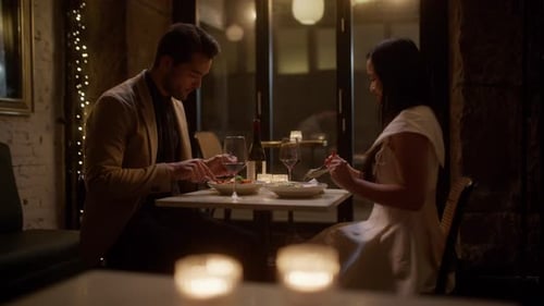 Couple Feeds Each Other Food During Restaurant Date