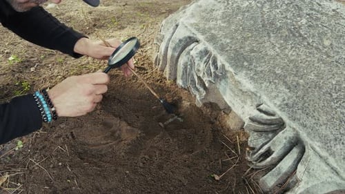 Archaeologist Cleans Ancient Christian Cross From Soil With Brush 3