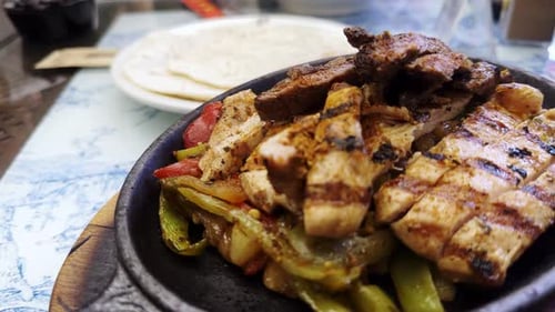 Delicious Sizzling Chicken and Beef Fajitas with Condiments