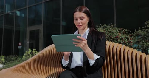 Businesswoman Holding Digital Tablet Device on City Street Glass Background Woman Using Tablet