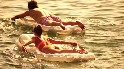 Summer Vacation Woman Floats on an Inflatable Mattress on Warm Sunset Time a Water Swim Toy Positive