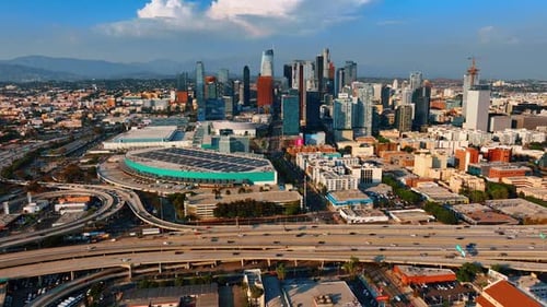 Multiple cars ride by the highways leading to and from Los Angeles downtown.