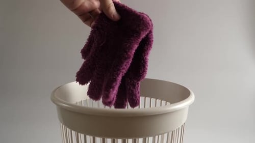 Purple Gloves Thrown in White Waste Basket