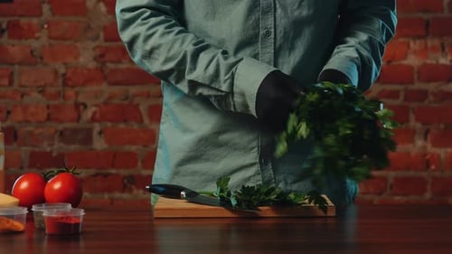 Chef Chops Fresh Parsley on Cutting Board