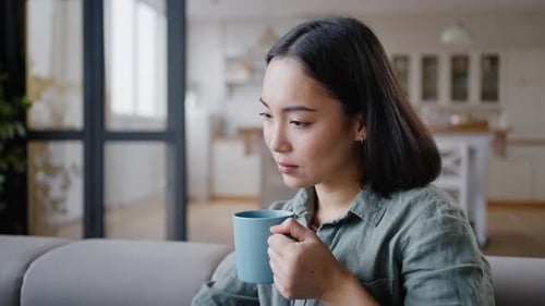 Woman Drinking Coffee and Relaxing at Home