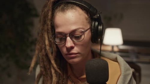 Female Radio Host Taking Notes on Digital Tablet