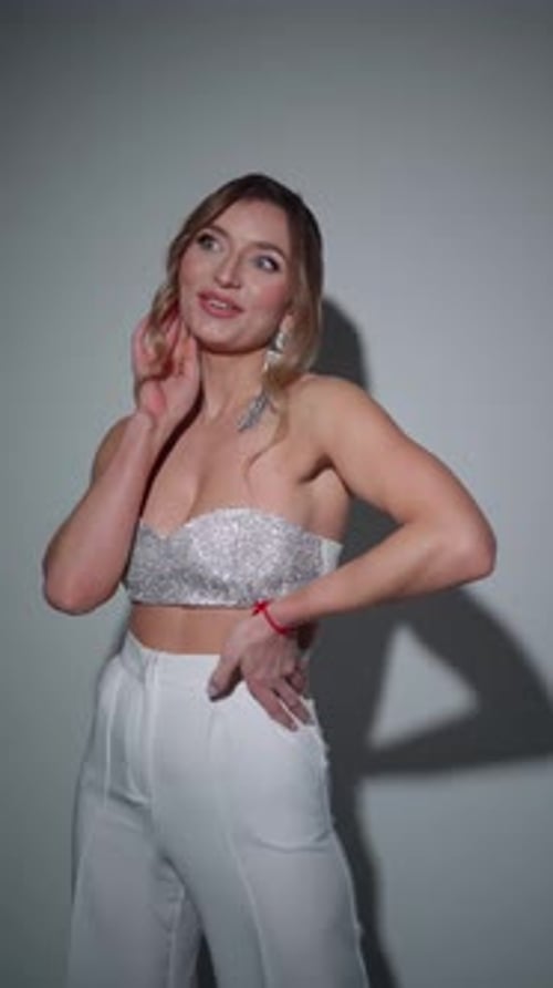 Smiling Woman Posing in Fashionable Outfit in Studio