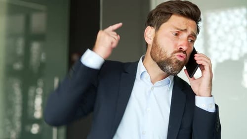 Man in Suit Talking on Phone in Office