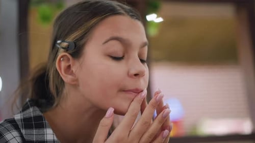 Young Woman Applying Makeup with Purple Sponge