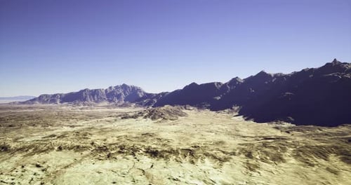 Large Barren Valley with Rugged Mountains and Stark Rocky Foregrounds