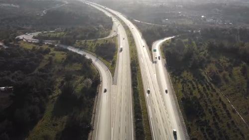 Aerial view of highway junctions with roundabout. Bridge roads shape circle in structure of architec