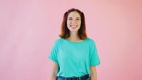 Smiling Woman Posing in Front of Pink Background