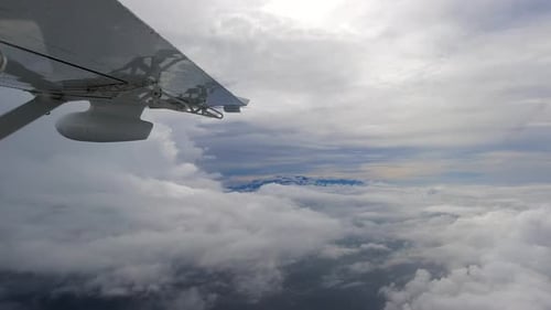Flying through the beautiful sunny heavenly landscape. White clouds gently moving in the sky and the