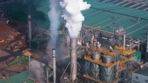 Smoke Coming Out From Chimney Of Industrial Plant. - aerial shot